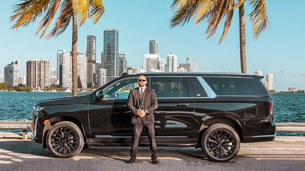 Driver Ready Beside a Cadillac Escalade for VIP Miami Limo Service